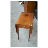 Early drop leaf end stand, having dingle drawer