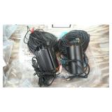 Two night owl surveillance cameras with cords.