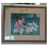 Framed print of little girl feeding rabbits, in