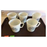 Five Pyrex coffee mugs with blue floral decor
