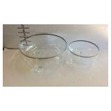 Two clear glass floral etched and tri-footed