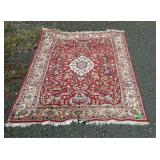 Wool oriental area rug measures 76 inches long,