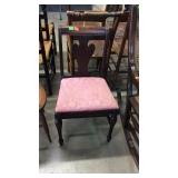 Single side chair with mauve colored fabric seat,