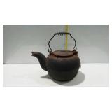 Cast iron camp fire tea kettle, shows age surface