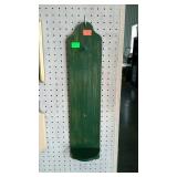 Narrow, green shelf with knob for candle or tall