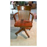 Solid oak desk chair, rocks, swivels, rolls and