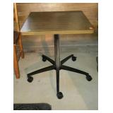 Square laminate table on wheels. Measures 24 x 24