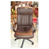 Brown executive desk chair, soft vinyl fabric.
