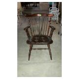 Spindle back wooden arm chair. Light surface