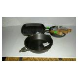 Three cast iron skillets with wooden handles not