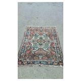 Wool oriental rug, measures 59 inches long, by 41