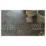 Three iron fireplace log crates, from smaller to