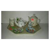 Teapots with Easter plates and cups