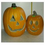 Two lighted artificial pumpkins
