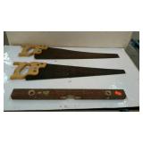 Two carpenters hand saws, and one 24" wooden
