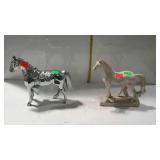 Two horse statues, one is metal