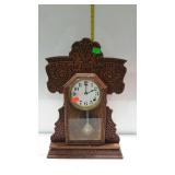 Gingerbread shelf clock with pendulum & key, has