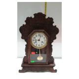 Gingerbread shelf clock with pendulum & key, has