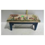 Footstool with needlework cover. Dated 1979. Some