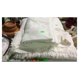 Group of white blankets and throw blankets