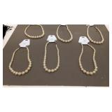 Six jaclyn Smith 18 inch faux pearl necklaces