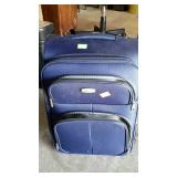 Small blue suit case, made by Lumi does have