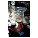 Home decor vase on stand with rocks and sand