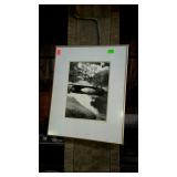 Framed black and white print of bridge and lake