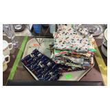 Stack of handcrafted tea towels, and hat display