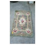 Green room rug, with flower border and flower