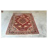 Wool oriental rug with flower center and border