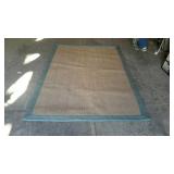 Wool area rug, with blue trim and brown center,