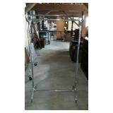 Metal storage rack with upper bar for storage