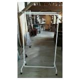 White metal clothes rack with top bar for storage