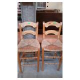 Two rush bottom counter stools with carved back