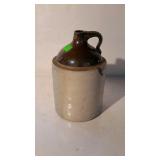 Stoneware jug - brown over white, 9.5" tall, chip