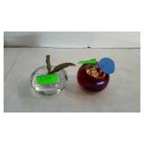 Two Apple shaped glass paper weights one colored