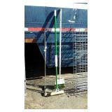 Two golf clubs, and broom and mop