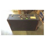 Black suitcase initials "E.H." No key shows some