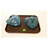 Two blue covered candy dishes