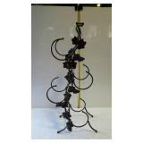Iron wine rack with grape leaf design, holds four