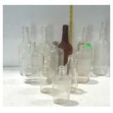 Bottles - mostly whiskey, one flask, and one