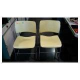 Four yellow metal chairs