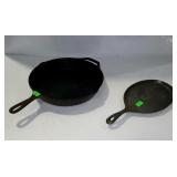 Two cast iron skillets, the bigger one is a lodge