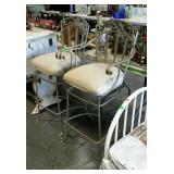 Pair of upholstered, armed, swivel barstools.