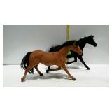Two flocked toy horses.