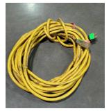 Yellow extension cord in used condition.
