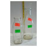 Two milk bottles. One pint and one quart.