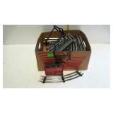 Box of Lionel train tracks and one transformer.