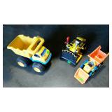 Group of three plastic toys. Dumptruck, bulldozer
